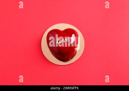 St. Valentine's Day. Delicious heart shaped cake on red background, top view Stock Photo