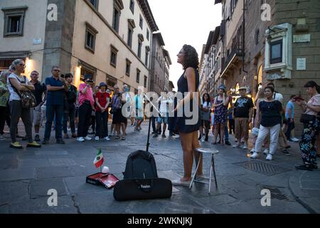 A young opera singer performs for tips in the Piazza del Duomo in Florence, Italy. Stock Photo