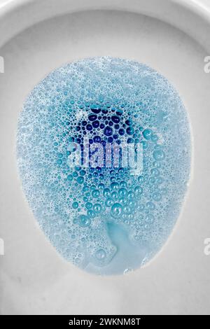 Blue toilet bowl cleaner bubbles in toilet Stock Photo