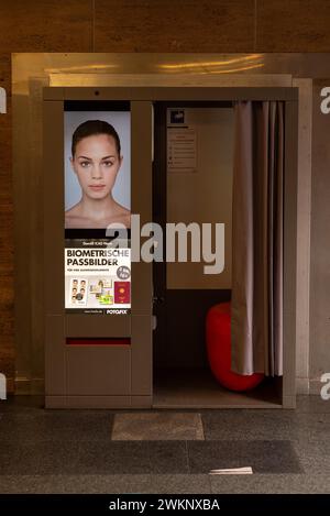 A photo booth for biometric passport photos with a female face on the advertising poster, Magdeburg, Saxony-Anhalt, Germany Stock Photo