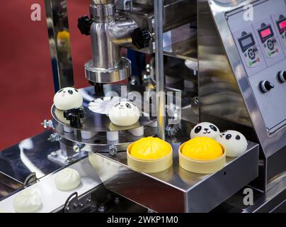 Food processing machine for steamed stuff bun. Stock Photo