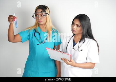 Two female doctors holding a clipboard, standing together Stock Photo