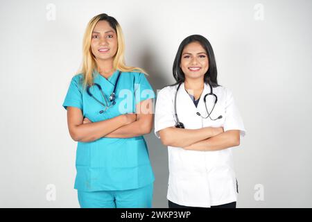 Two healthcare professionals in scrubs posing together for a photograph Stock Photo