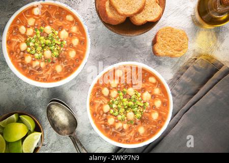 Vegetarian Moroccan Harira soup. It's a classic Moroccan lentil and chickpeas soup with fresh herbs and loads of warm spices. Served with fresh lemon. Stock Photo