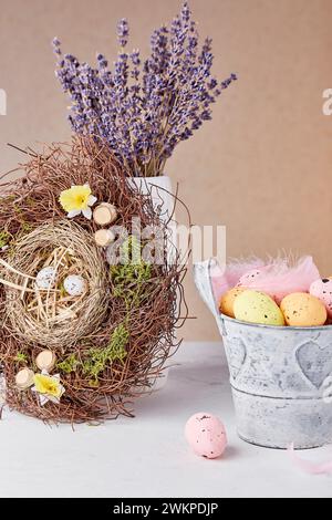 Bouquet of lavender, nest, bucket with Easter eggs - Easter decorations Stock Photo