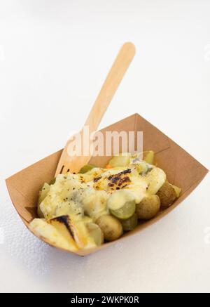 A wooden bowl filled with potato salad and topped with chives Stock Photo