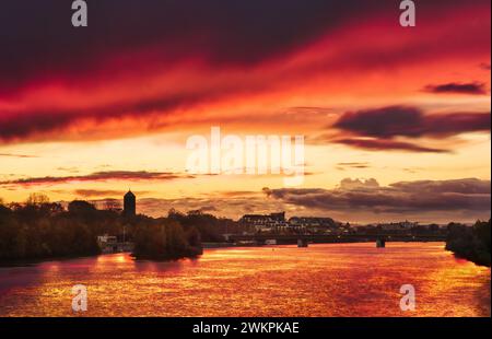 Dramatic stunning red sky at sunset, a romantic scenery over the Neckar river in Heidelberg, Germany Stock Photo
