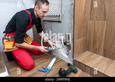 Construction man using hammer and tool while demolish wall Stock Photo