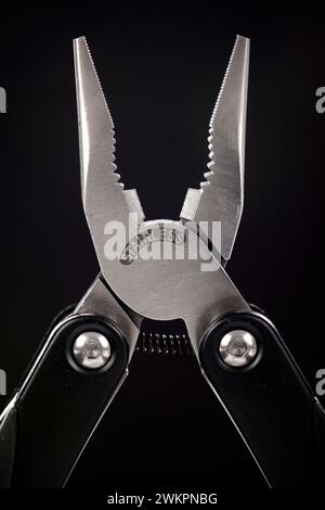 Close up of a multi-tool on a black background Stock Photo