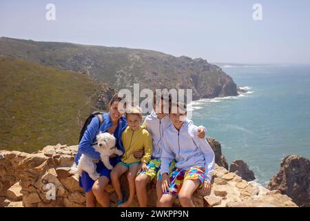 Family with children, siblings, visiting the most west point of Europe, Cabo Da Roca, during family vacation summertime in Portugal Stock Photo