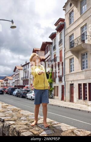 Family, visiting small town in France, Saint Jean de Luz, during summer vacation, traveling with children in Europe Stock Photo