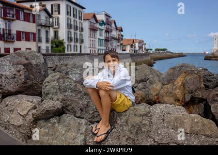 Family, visiting small town in France, Saint Jean de Luz, during summer vacation, traveling with children in Europe Stock Photo