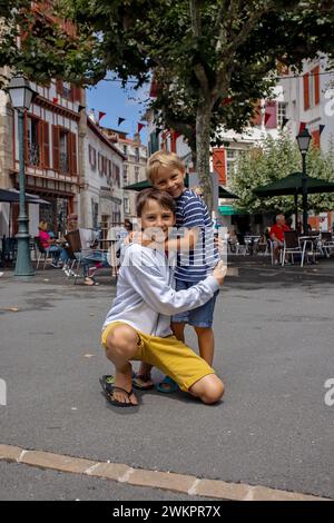 Family, visiting small town in France, Saint Jean de Luz, during summer vacation, traveling with children in Europe Stock Photo