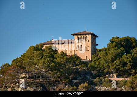 Marivent palace seen from a low angle surrounded by trees in Palma de Mallorca Spain Stock Photo