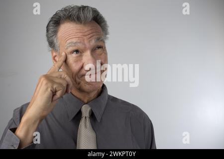 An elderly man in deep thoughts Stock Photo