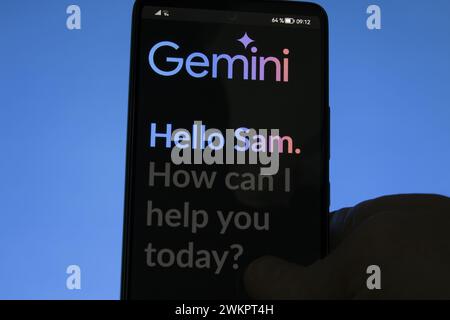 Gemini on his phone. Goggle Bard Gemini web app on a screen. Stock Photo