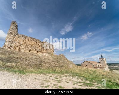 Angled views of the remains of Cogullo castle and Santa Maria church on a summer day with blue sky. Rural landscape in the countryside. Cogolludo Stock Photo
