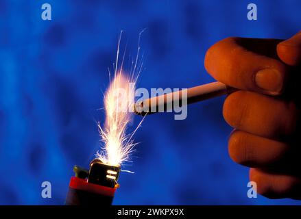 lighter and hand with cigarette Stock Photo