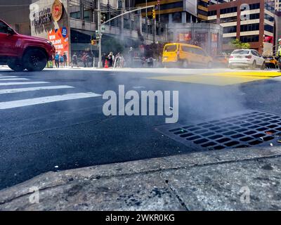 New York, USA; June 4, 2023: Smoke coming from the underworld of the Big Apple, coming out into the streets through the vents in the ground of Manhatt Stock Photo