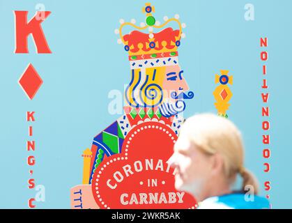 Pedestrians walk past the decoration for the coronation near Carnaby Street as London prepares for the coronation of King Charles III. Stock Photo