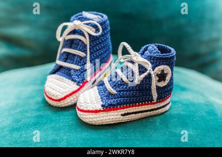 Little knitted handmade soft footwear for a toddler Stock Photo
