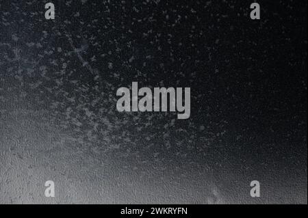 Black plastic background with gray spots macro close up view Stock Photo