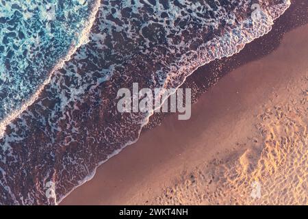 Top view of the surf lie. Waves and sandy beach. Artistic red-green gradient color Stock Photo
