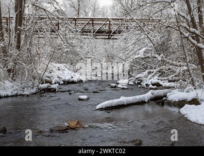 Crisp, new-fallen snow on Van Tassel footbridge as it crosses Paint Creek, in Orion Township, Michigan. Stock Photo