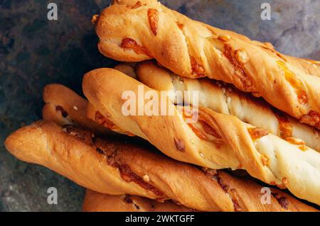 handmade grissini. Italian grissini or salted breadsticks with parmesan and onions on a light stone background. Fresh Italian appetizer. Copy space. C Stock Photo