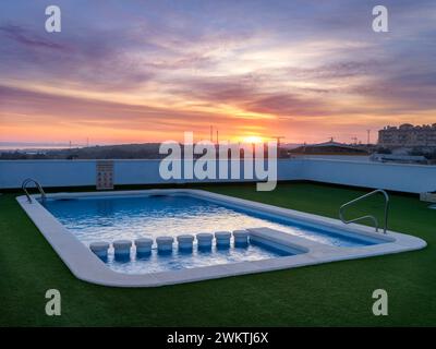 A rooftop swimming pool at sunrise on a January morning in San Miguel de Salinas, Alicante, Spain. Stock Photo