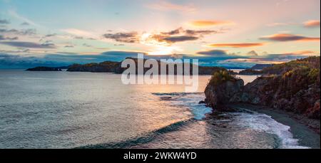 The sun shining on beach and cliffs Stock Photo