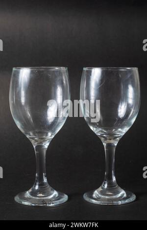 Closeup shot of two empty wine glasses on black background Stock Photo