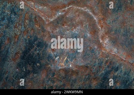 Abstract background from an old metal sheet with dents, worn paint and traces of corrosion Stock Photo