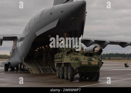 A C-17 Globemaster III and a Stryker vehicle are displayed for the Chief of Staff of the Indian Army Gen. Manoj Pande and his delegation during their tour at Joint Base Lewis-McChord, Washington, Feb. 15, 2024. The visit was part of a tour to strengthen U.S. and India relations and interoperability. (U.S. Air Force photo by Airman 1st Class Megan Geiger) Stock Photo