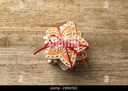 Tasty Christmas cookies with icing on wooden table, top view Stock Photo