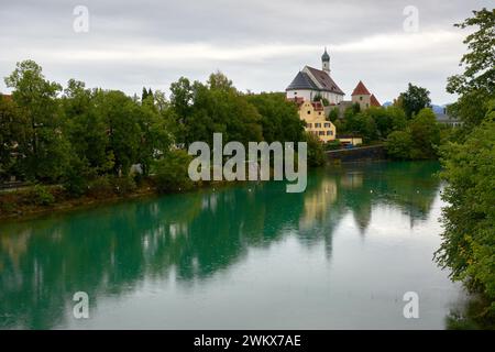 River Lech in Fussen and the Historic Franciscan Monastery. The Lech river in Fussen Bavaria, Germany and the Franciscan Monastery of St Stephen. Stock Photo