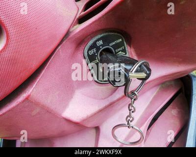The motorbike starter key is installed in the motorbike ignition hole Stock Photo