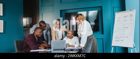 Group of business people communicating and collaborating. A woman actively participating, sharing ideas with the group. Strong teamwork and collective Stock Photo