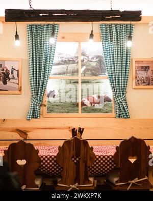 Top-down view checkered blanket, overflowing basket with food, wine glasses, cheese, and crackers Stock Photo