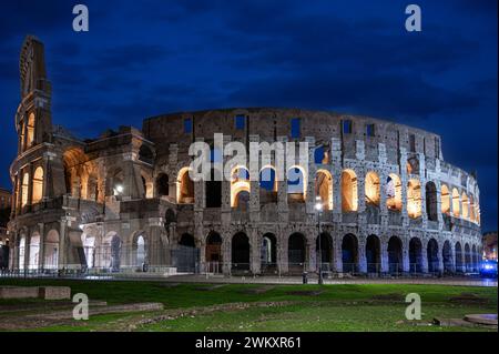 The majestic Rome Colosseum stands illuminated against the night sky in Italy Stock Photo