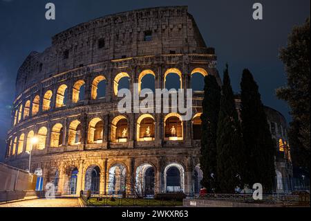 The majestic Rome Colosseum stands illuminated against the night sky in Italy Stock Photo