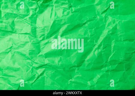 texture of matte green crumpled paper background. paper textures and backgrounds. Stock Photo