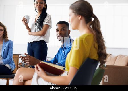 Collaboration, read and listen in meeting for article, business people, research and writing. Diverse, colleagues and journalists for career, startup Stock Photo