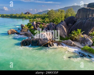 Aerial view of a tropical island with a turquoise lagoon, lush green ...
