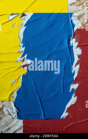 Peeled blue, yellow and red paper poster texture background Stock Photo