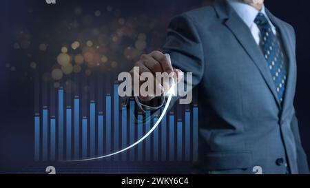 Businessman drawing a business growth line on concept of financial planning and a return on investment analysis Stock Photo
