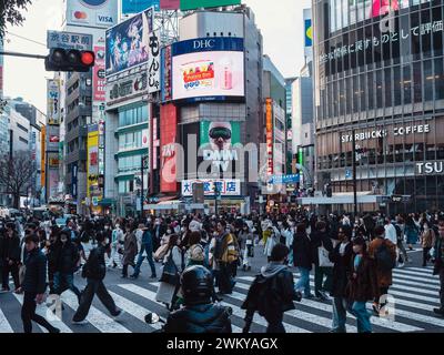 Tokyo - March 6, 2023 : Shibuya - the famous cross road of Japan. Full of crowd walking on the street and full of products branding on the building. Stock Photo