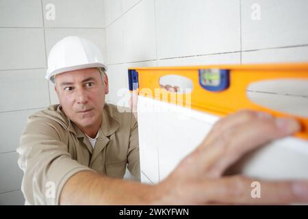 man repair man measuring kitchen cabinet Stock Photo