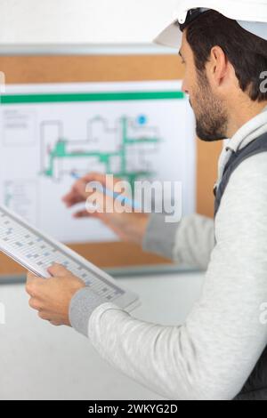 architect checking insulation during house construction Stock Photo