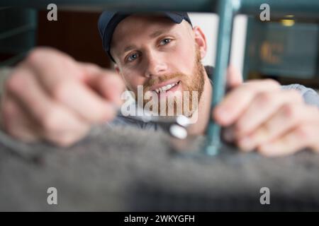 happy workman in uniform working with tools Stock Photo